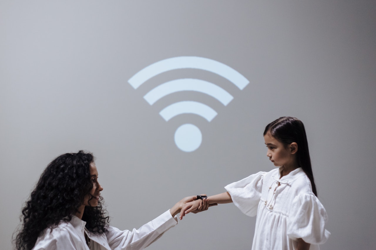 Woman and girl are holding hand in a sign of wi-fi connection